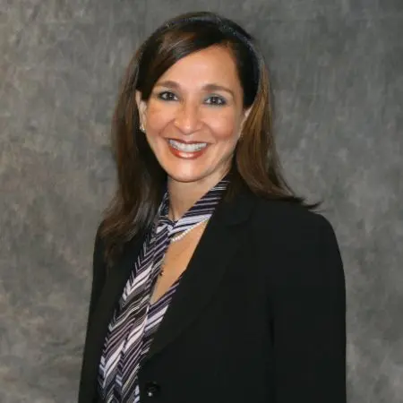 A woman in a black jacket and striped tie.